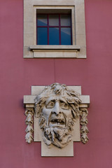 Creepy face sculpture and window above it. S. João National Theater, Porto, Portugal