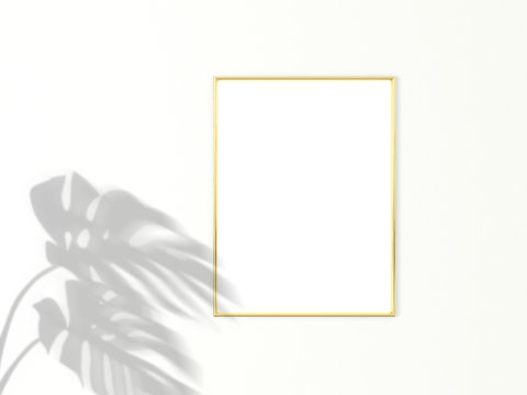 3x4 vertical Gold frame for photo or picture mockup on white background with shadow of monstera leaves. 3D rendering.