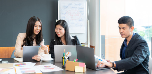 Asian Businessmen are brainstorming in the meeting room. There is a discussion of the strategy of working in accordance with the world economic remnants.