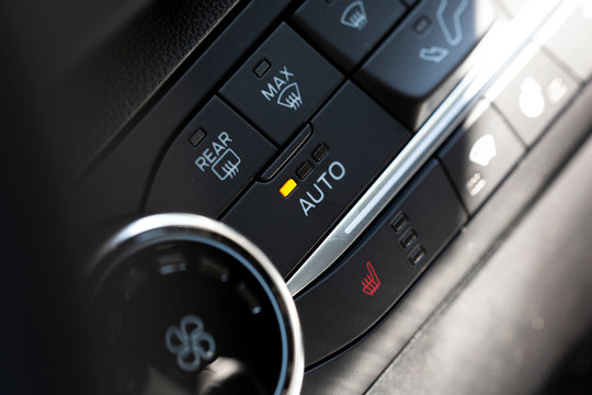 Auto button switch on a modern car. Button for air condition and rear window heating.