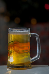 Glass of beer on a background of illumination