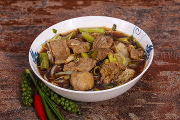 Thai style soup with meat and mushrooms