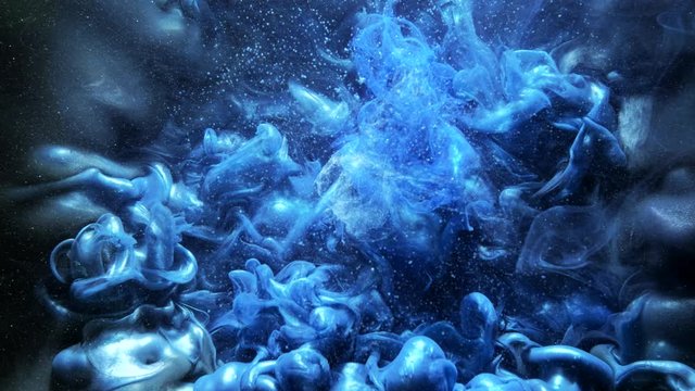 Ink motion. Mysterious cloud. Blue glitter flow. Acrylic paint splash.