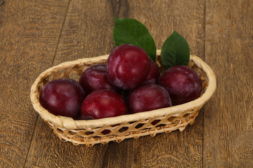 Plum heap in the wooden basket