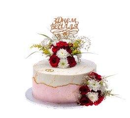 Wedding cake with rings and topper, on a white background.