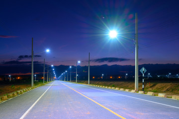 Empty Road at night with Electric Power Light