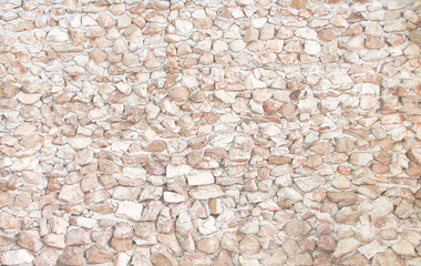 Nature stone texture in overlap seamless patterns shaped on concrete wall light brown background