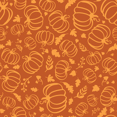 Autumn seamless pattern of silhouette of pumpkins and maple leaves.