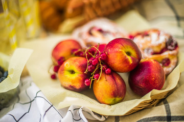 Currant berries on the background of ripe peaches