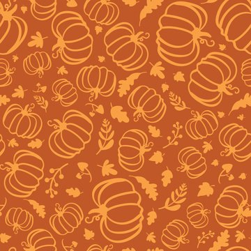 Autumn seamless pattern of silhouette of pumpkins and maple leaves.