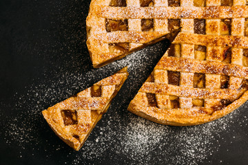 Pastry dessert. Apple pie with cinnamon sprinkled with sugar powder.
