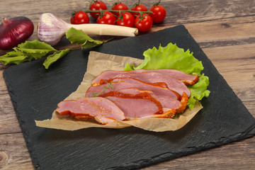 Sliced smoked duck breast served salad
