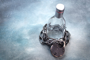 Alcoholism, alcohol addiction concept with alcohol drink bottle and chain with lock. Stop drink...