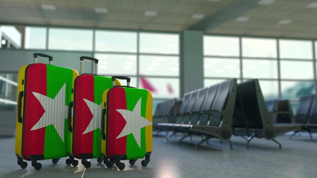 Travel suitcases with flag of Myanmar. Myanma tourism conceptual 3D animation