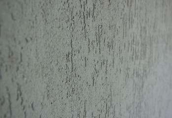 Green wall, stucco. Rough embossed surface. Background, texture. Close-up.
