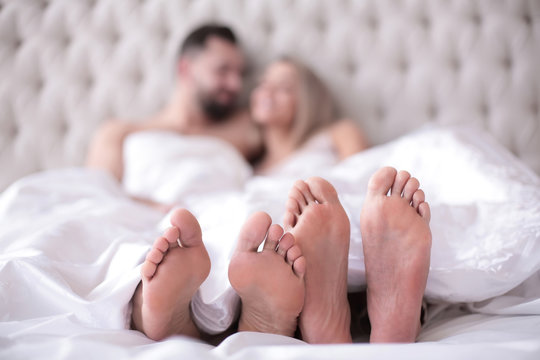 background image of a couple in love lying on the bed
