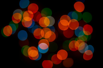 Abstract surface of bokeh, colorful, blurry background, blurred glare, large circular spots.Bright lights on dark background.