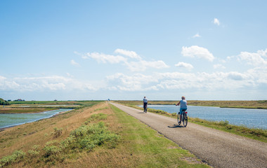 Fototapeta premium Cyclists on a Dutch dike