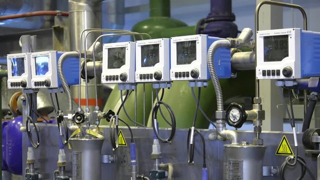 Equipment, cables and piping as found inside of a modern industrial power plant. 4-channel transmitter.  Expandable multiparameter field device for all industries