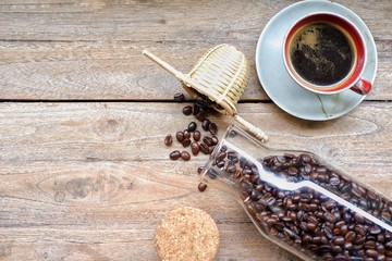 cup of coffee and beans on wooden table