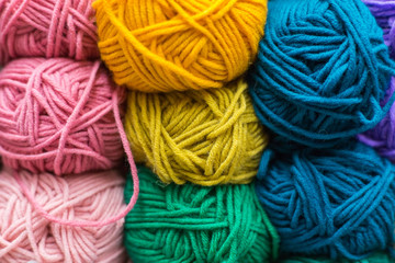 Shelf with a lot of color yarn for diy knitting. Selection of colorful yarn wool on shopfront. Knitting background. Knitting balls of wool, crochet hooks pattern.