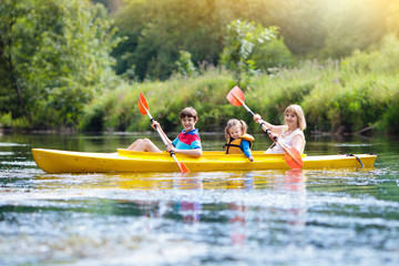 Child on kayak. Kids on canoe. Summer camping.