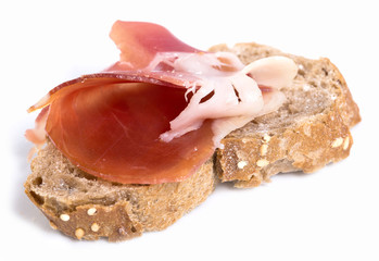 sandwich made with rye bread and Parma ham on isolated background