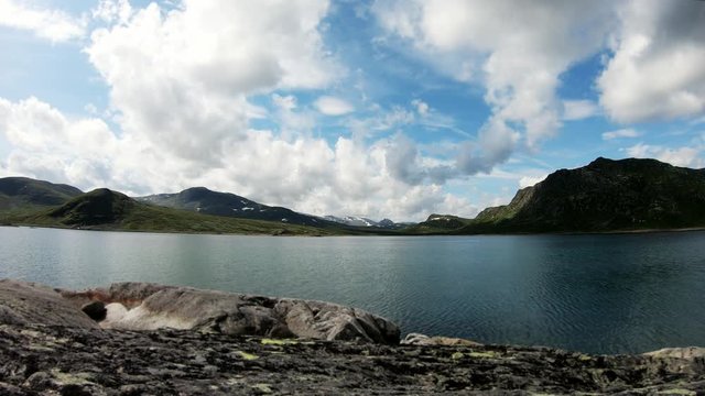 Time Lapse footage. Jotunheimen National park, Norway. View to the beautiful mountain lake in the sunny weather.