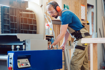 Carpenter working at the circular cutter