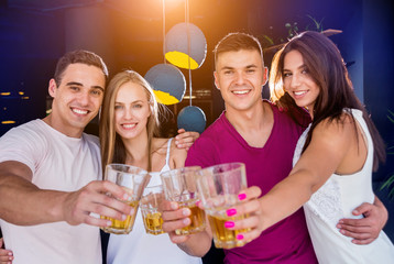 Cheerful friends in the pub. Drinking beer, talking, having fun.