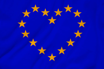 stylized European Union flag, symbol of united Europe on soft silk with soft folds, close-up