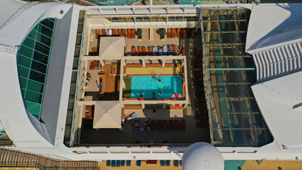 Aerial top view photo of huge open deck cruise liner ship docked in marina