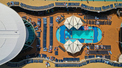 Aerial top view photo of huge open deck cruise liner ship docked in marina