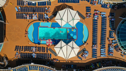 Aerial top view photo of huge open deck cruise liner ship docked in marina