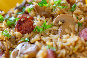 Rice salad with pork sausages, brown mushrooms and parsley