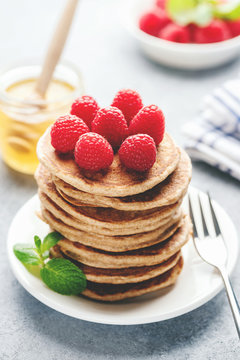 Stack of pancakes with rasbperries, vertical composition, toned image
