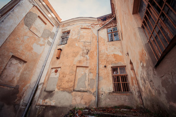 Fototapeta na wymiar Walls with windows of old abandoned mansion palace