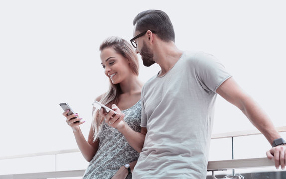 Young Couple Reading Text Message On Smartphone