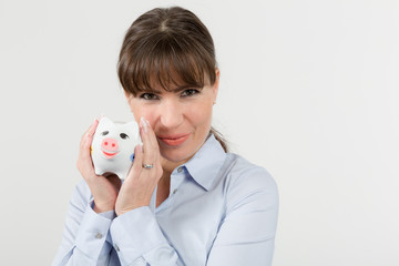 Fototapeta na wymiar happy woman cuddling with a piggy bank 