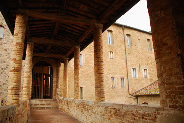 Fototapeta na wymiar A covered walkway in old brick building in the historic Tuscan hill town of San Gimignano