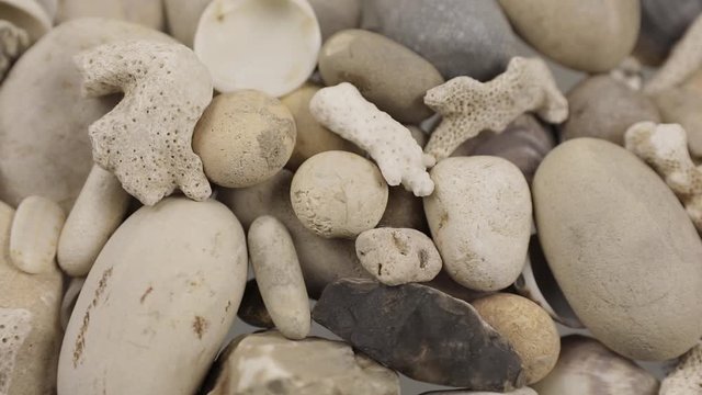 Camera slowly slides over sea pebble from right to left