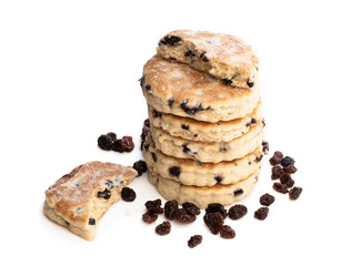 Stack of iced Welsh cakes with raisins isolated on white