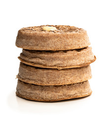 Stack of wholemeal crumpets isolated on white background
