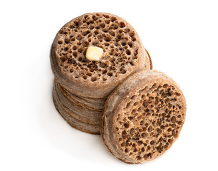 Stack of wholemeal crumpets isolated on white background