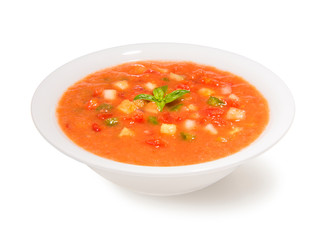 Traditional spanish cold gazpacho soup in a bowl on a white background