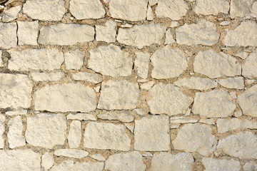 Texture of old yellow stone. Sandstone background.