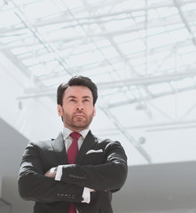 confident businessman standing in a spacious office