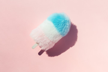 Creative flat lay of pastel color fluffy fur ice cream close up with copy space on pink summer background. Minimal zine type