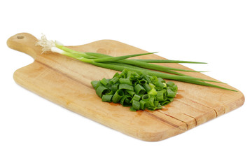 chopped green onions on a wooden board