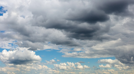 Fototapeta na wymiar Cumulonimbus clouds in the blue sky. Harbingers of rain. Sky pattern. 
